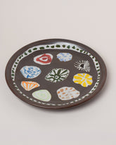 Maggie Boyd Tenmoku Petal Platter on light color background.