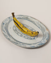 Maggie Boyd Trompe LOL Banana Platter on light color background.