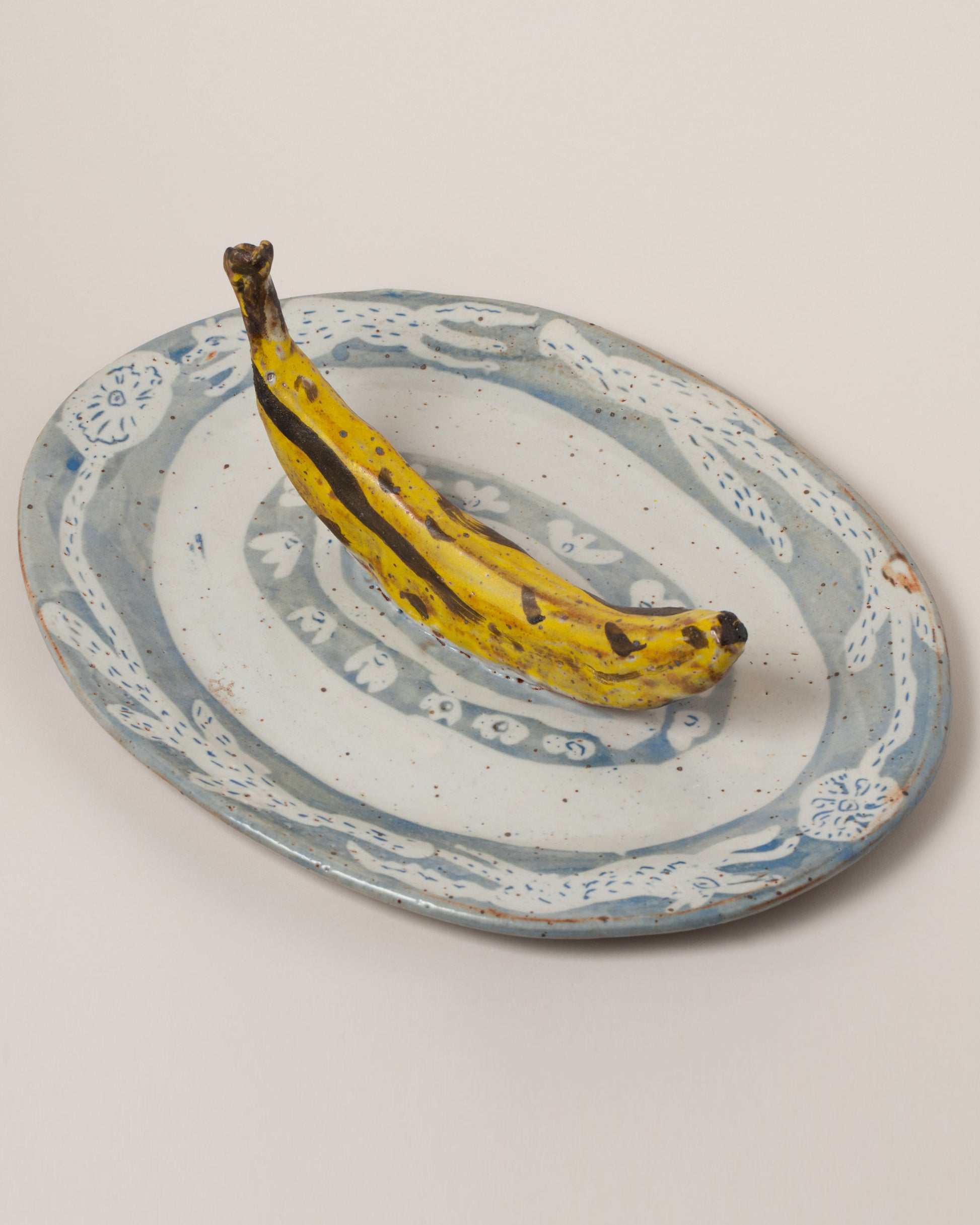 Maggie Boyd Trompe LOL Banana Platter on light color background.