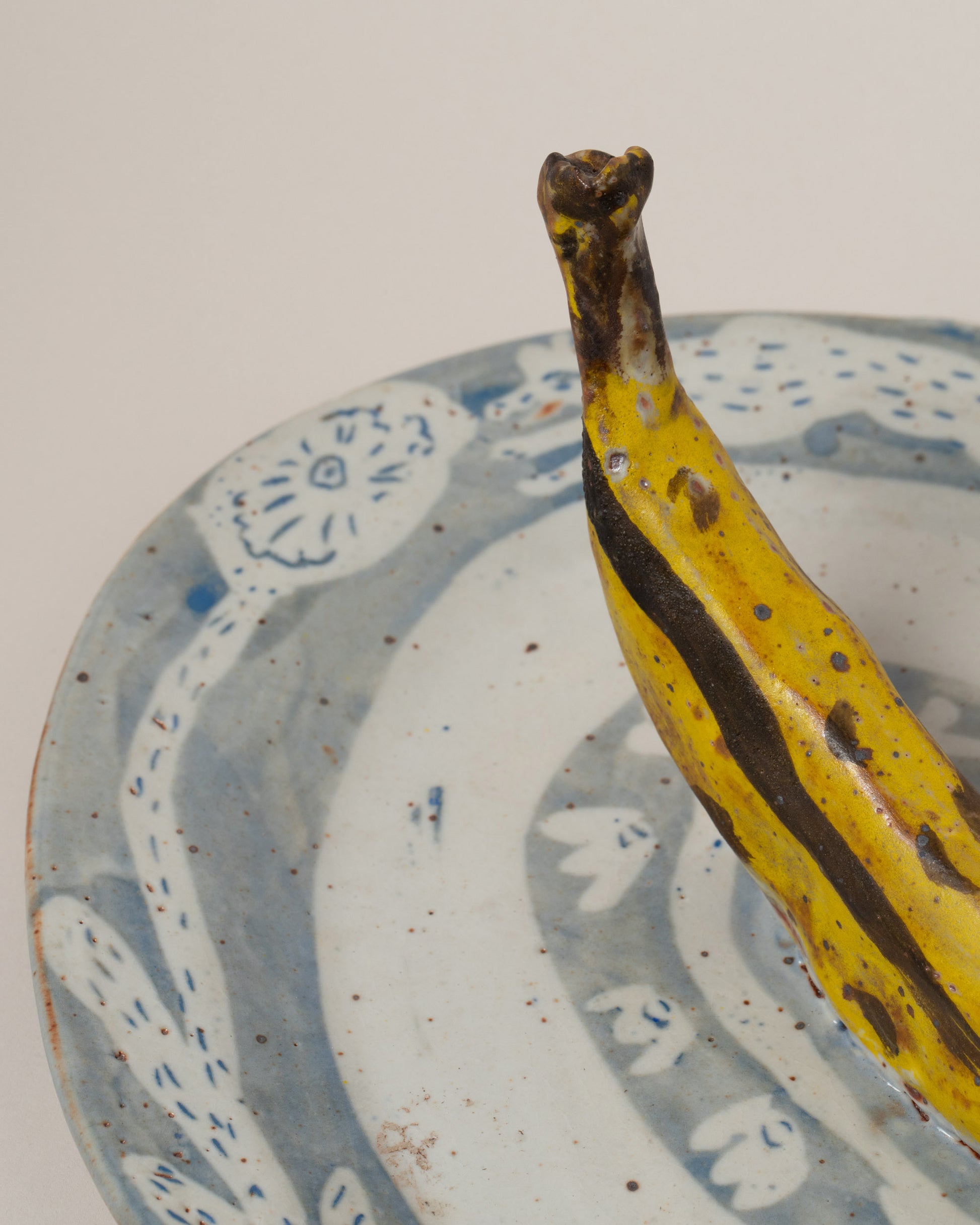 Closeup details of the Maggie Boyd Trompe LOL Banana Platter on light color background.