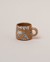 Maggie Boyd Ambrosia Birds Mug on light color background.