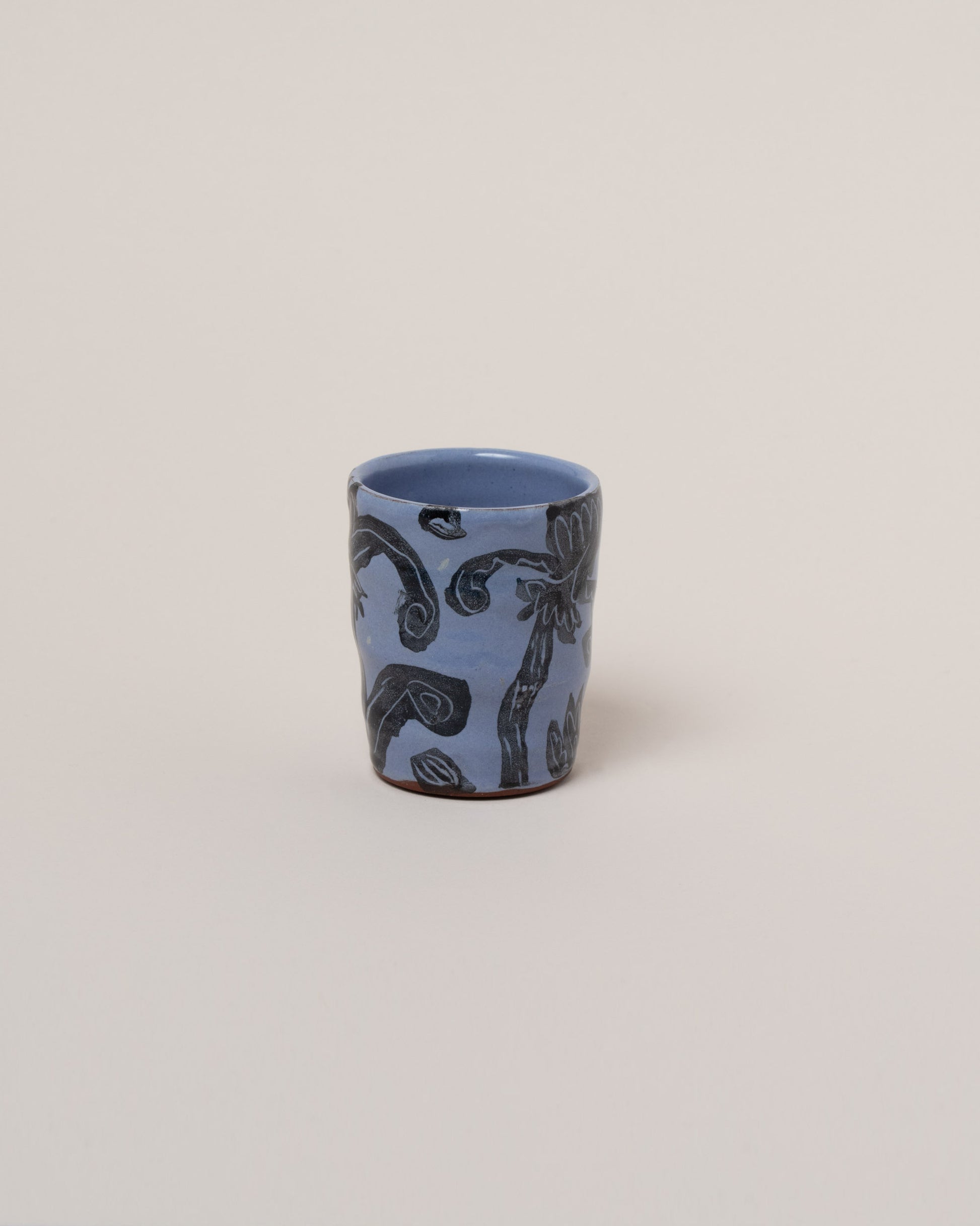 Maggie Boyd Blue One Black Flower Tumbler on light color background.