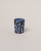 Maggie Boyd Blue Two Black Flower Tumbler on light color background.