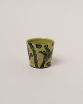 Maggie Boyd Chartreuse One Black Flower Tumbler on light color background.