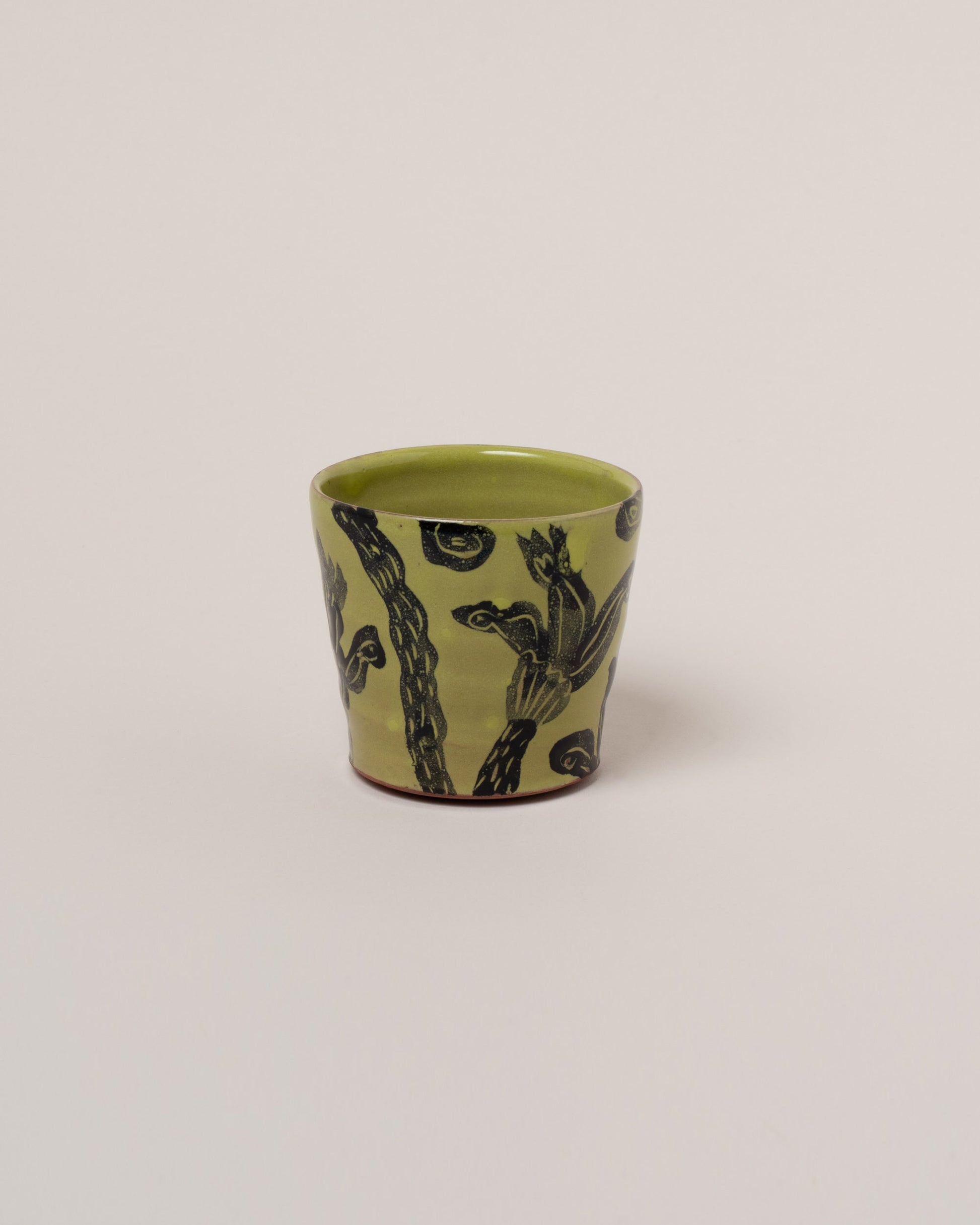 Maggie Boyd Chartreuse One Black Flower Tumbler on light color background.