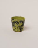 Maggie Boyd Chartreuse Two Black Flower Tumbler on light color background.