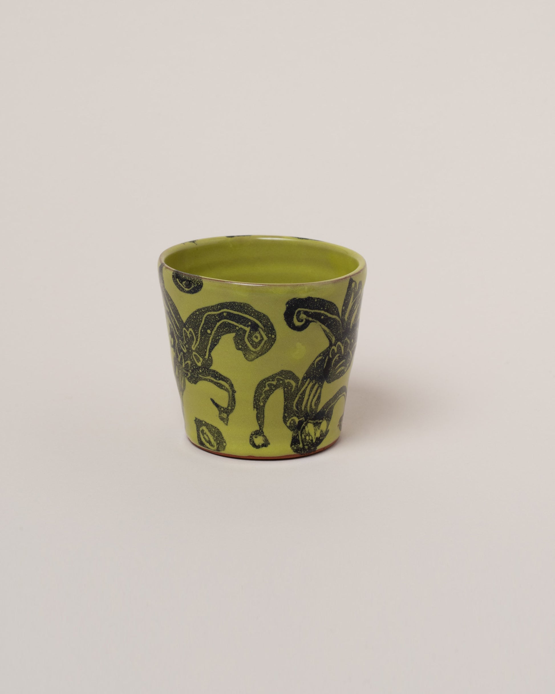 Maggie Boyd Chartreuse Two Black Flower Tumbler on light color background.
