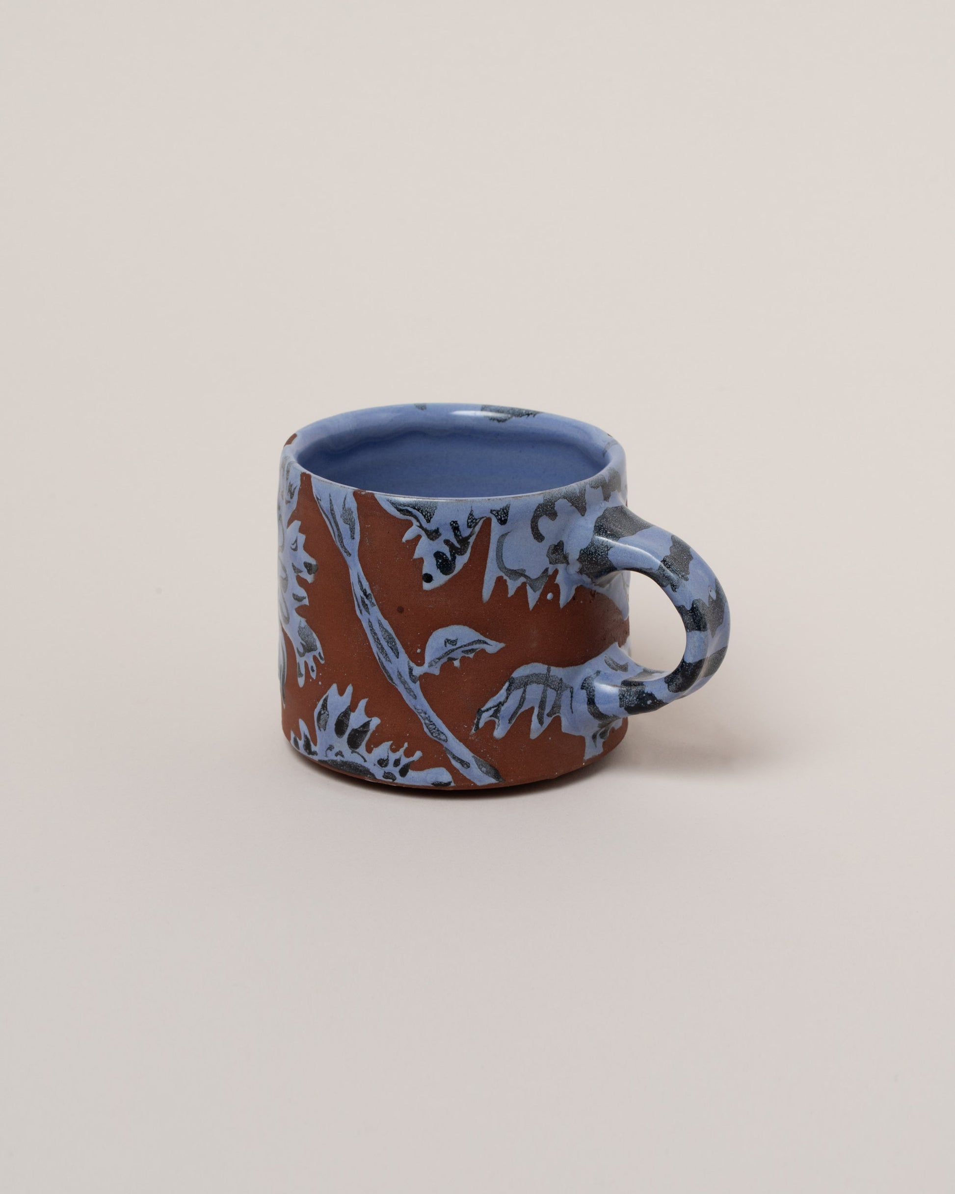 Maggie Boyd Blue Clay Flower Mug on light color background.