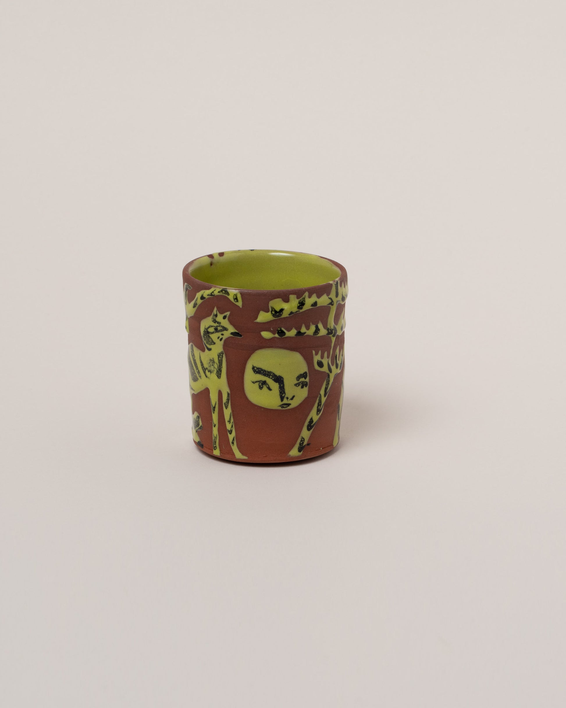 Maggie Boyd One Chartreuse & Black Figure Tumbler on light color background.