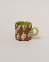 Maggie Boyd Chartreuse Jester Mug on light color background.