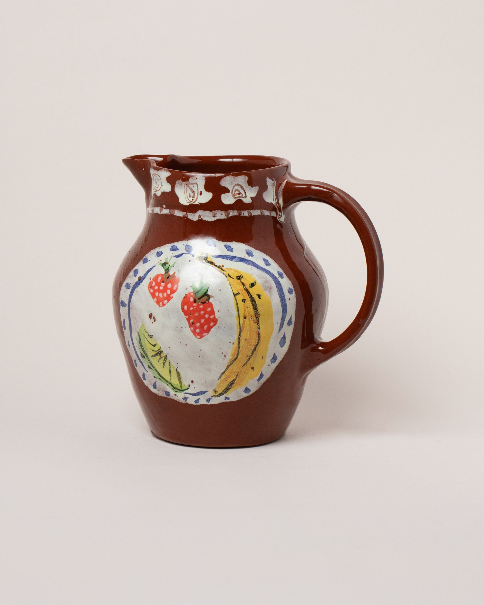 Maggie Boyd Chocolate Dinner Plate Pitcher on light color background.