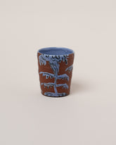 Maggie Boyd Blue Two Clay Flower Tumbler on light color background.