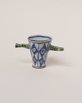 Maggie Boyd One Green Sardine Cup on light color background.