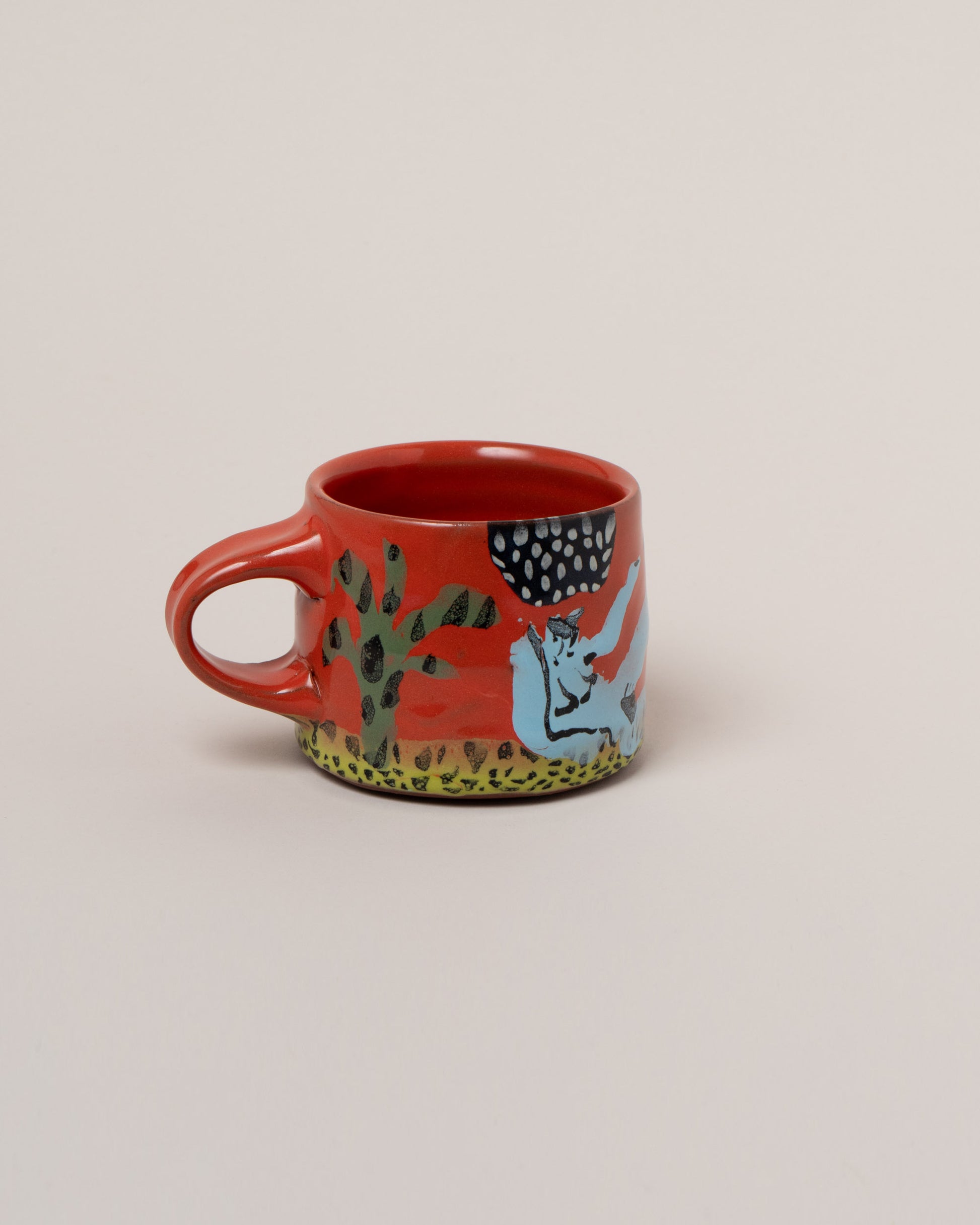 Maggie Boyd Blue Lady Lounges Mug on light color background.