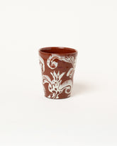 Maggie Boyd One Chocolate & White Flower Tumbler on light color background.