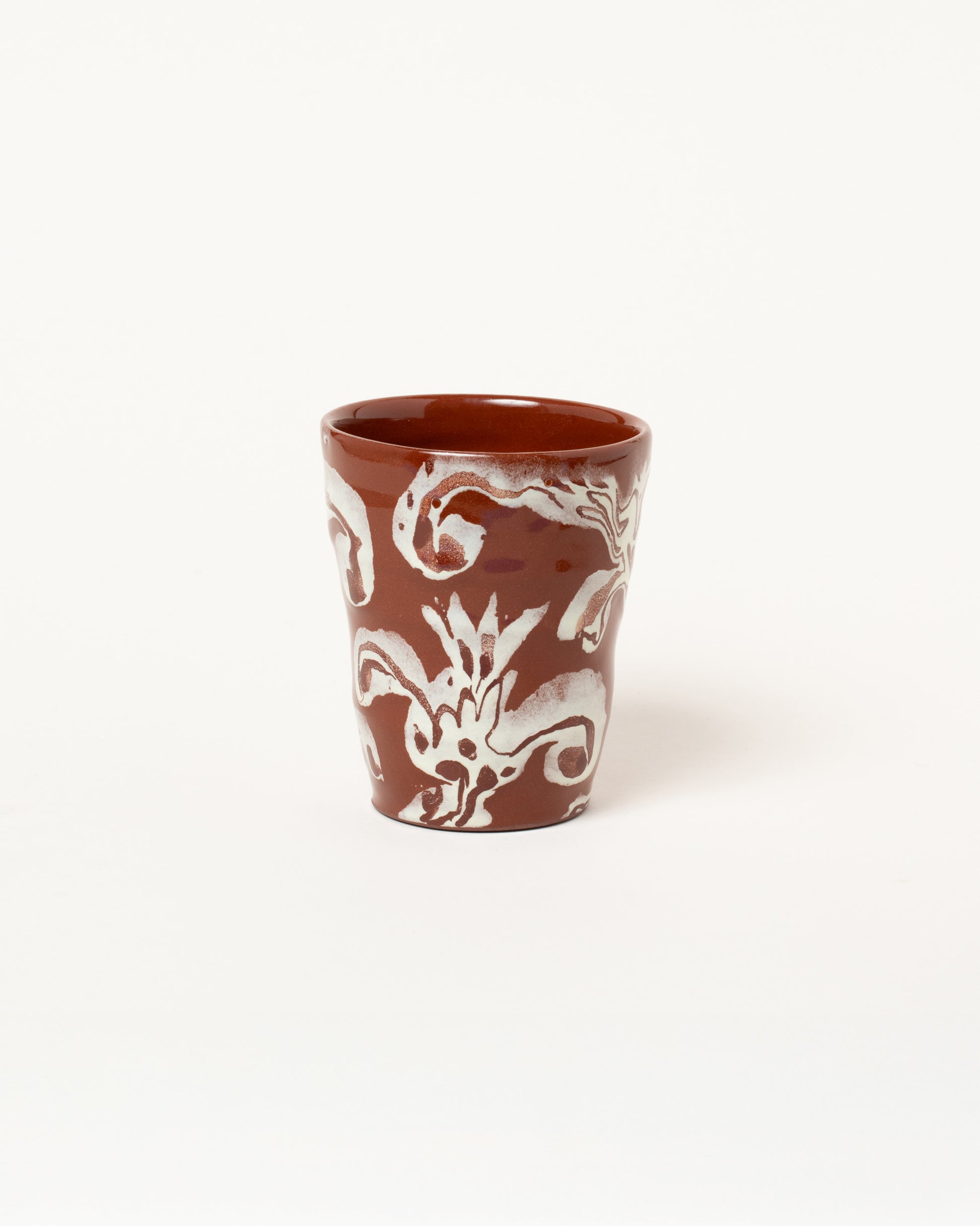 Maggie Boyd One Chocolate & White Flower Tumbler on light color background.