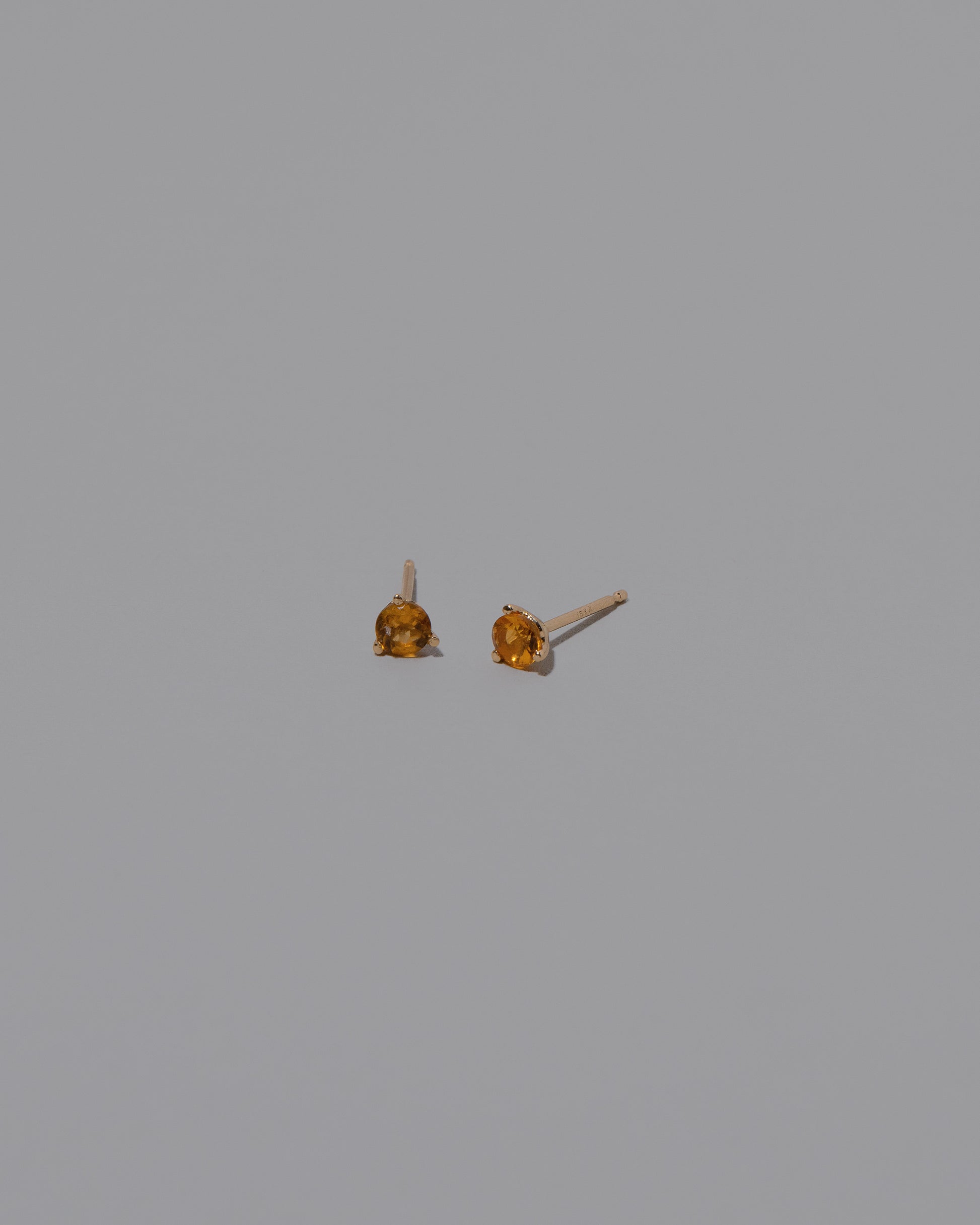 Petite Citrine Martini Stud Earrings on light color background.