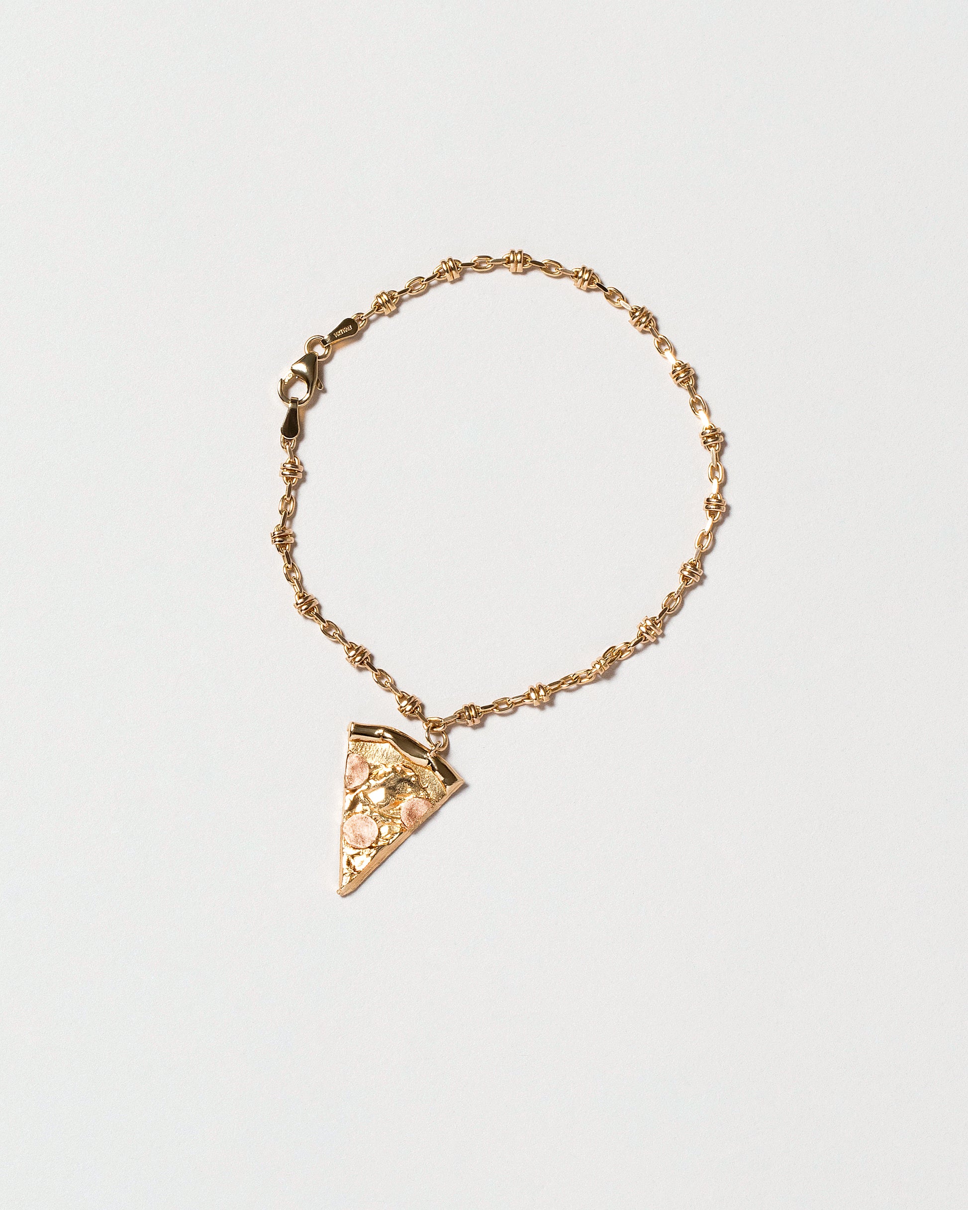 Wrapped Chain Bracelet with Pizza Slice charm on light color background.