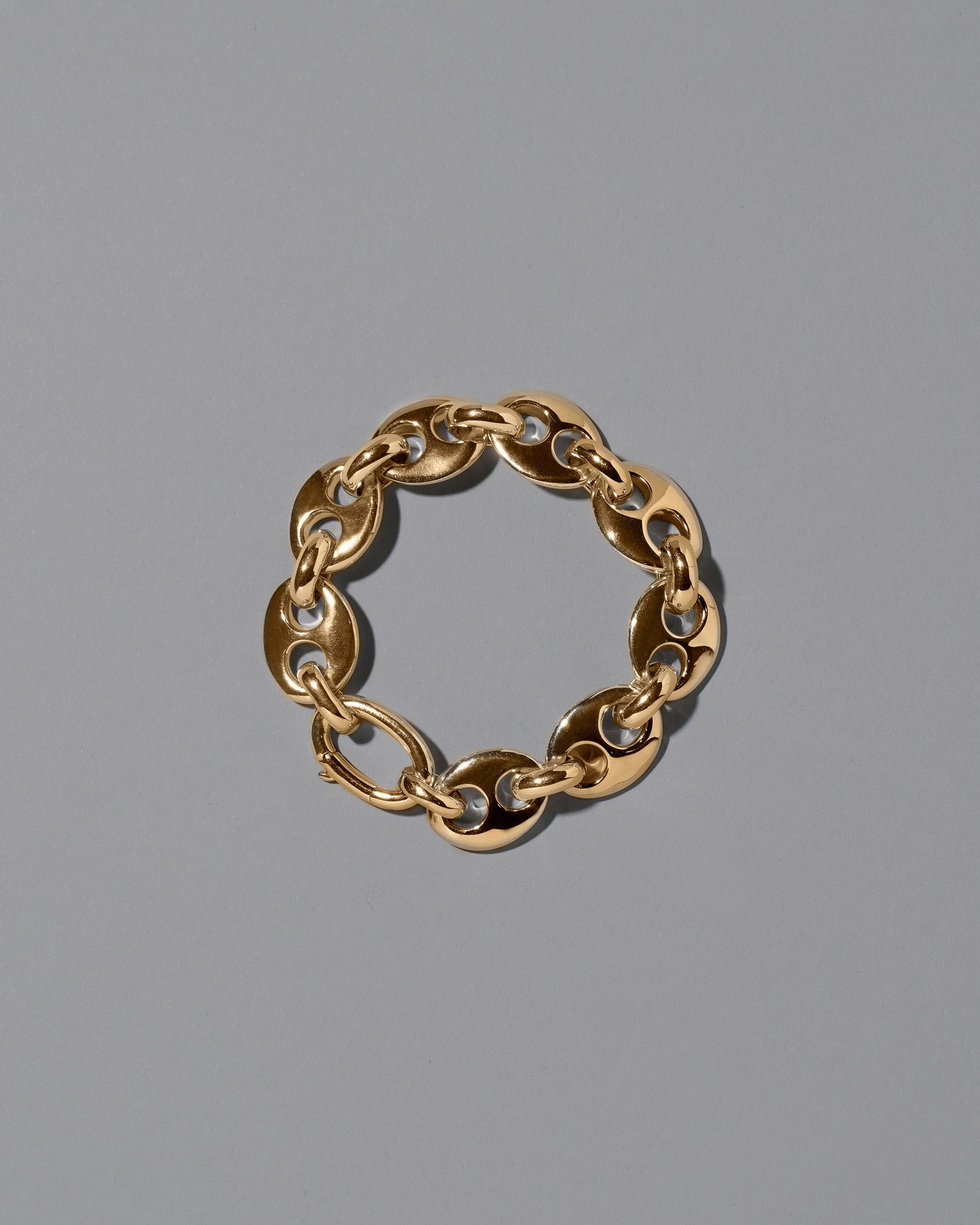 CRZM Gold Bedrock Bracelet on light color background.