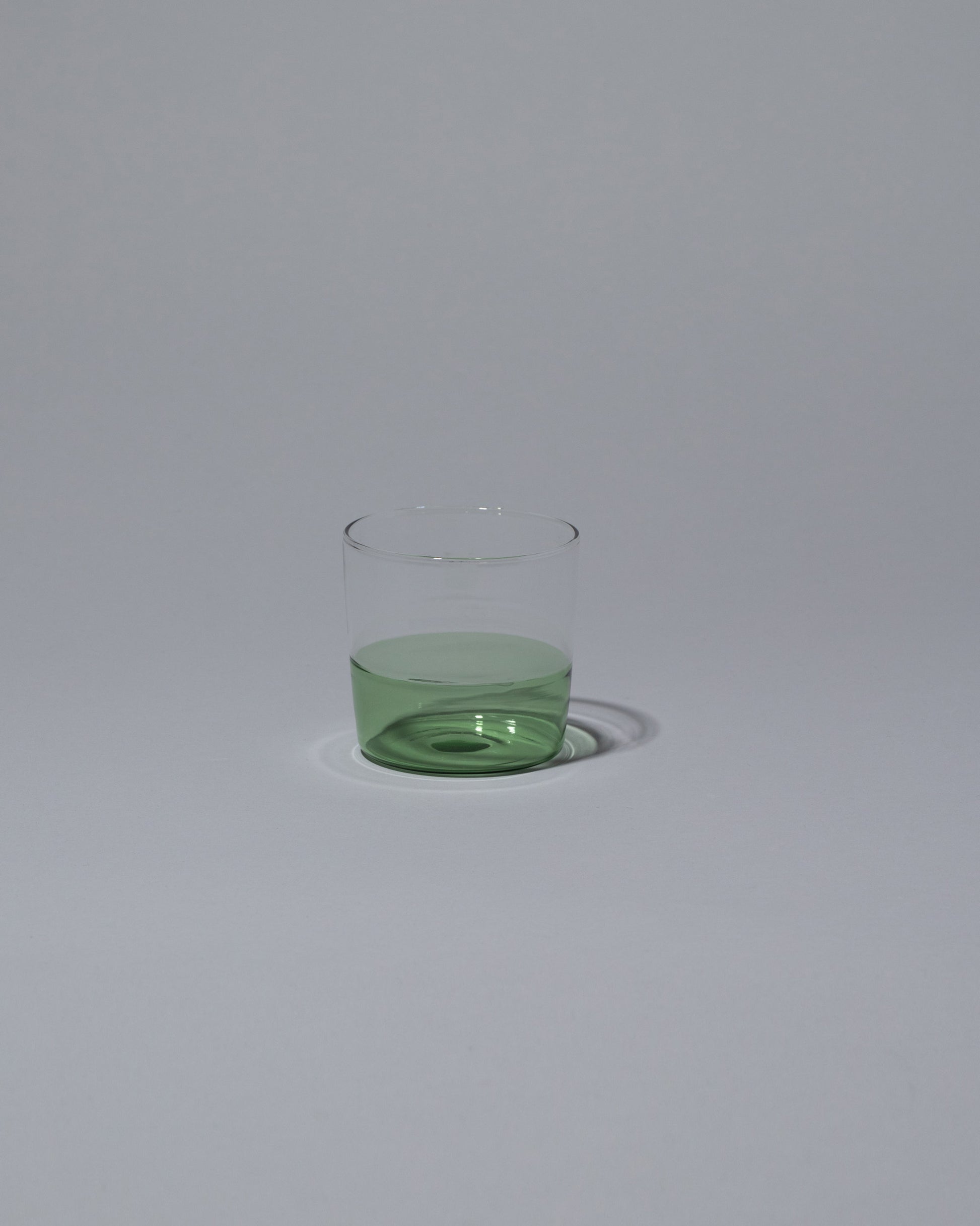 Ichendorf Milano Green/Clear Light Colore Water Glass on light color background.