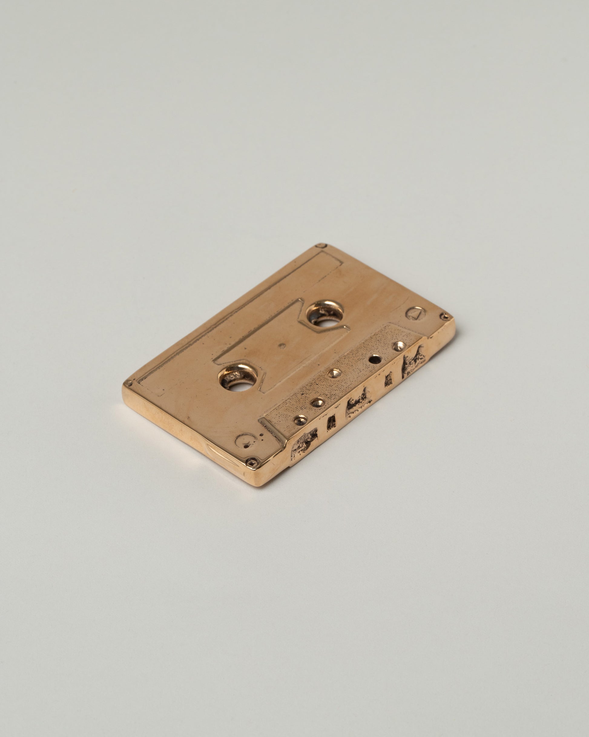 Pearce Objects Cast Brass Mix Tape on light color background.