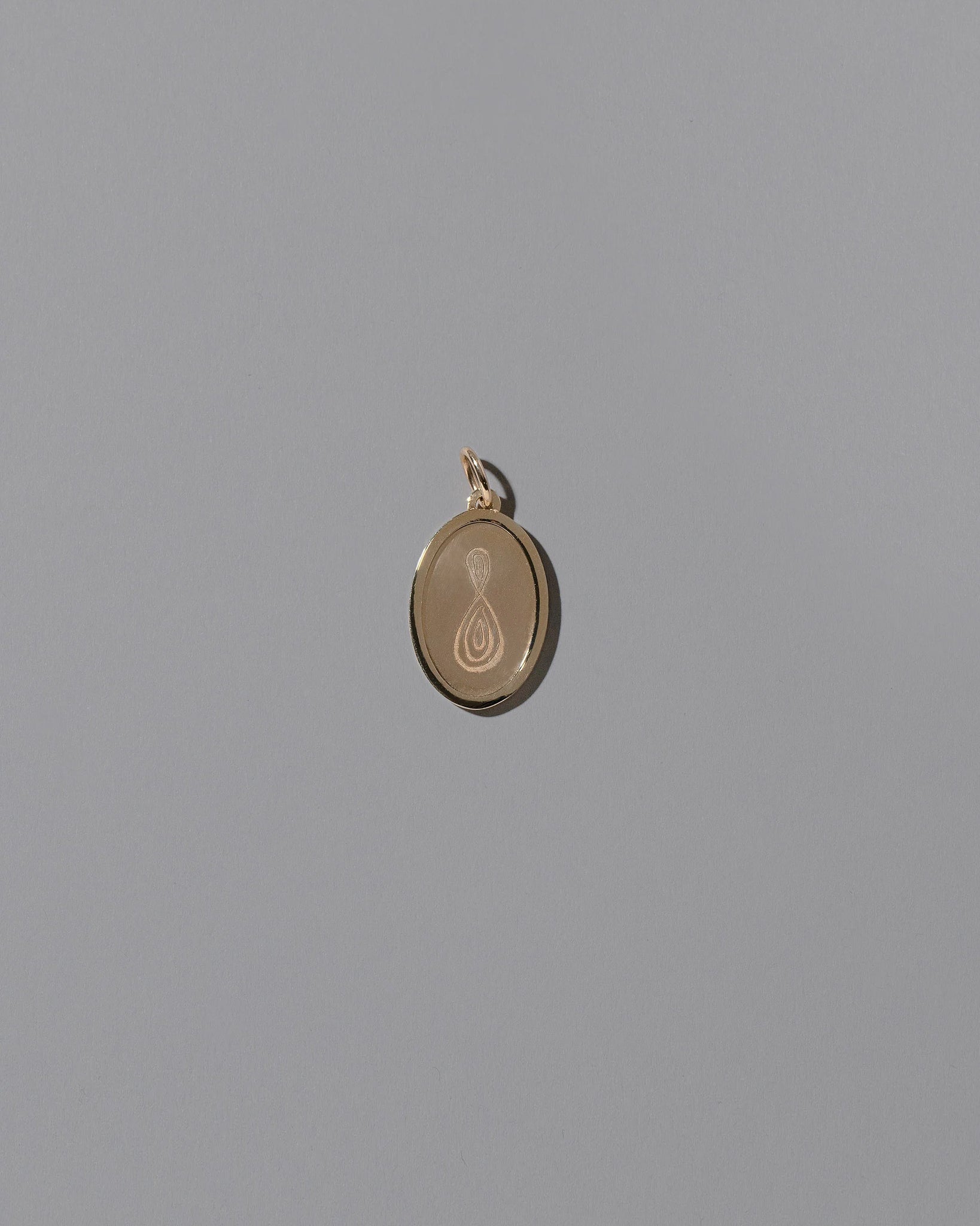 Finished Large Oval Memento Pendant on light color background.