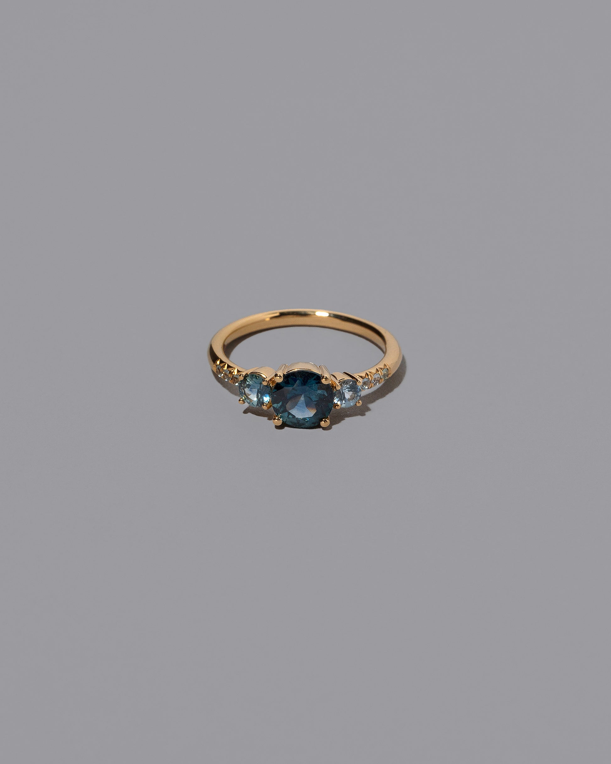 Sapphire Orion Ring on grey color background.