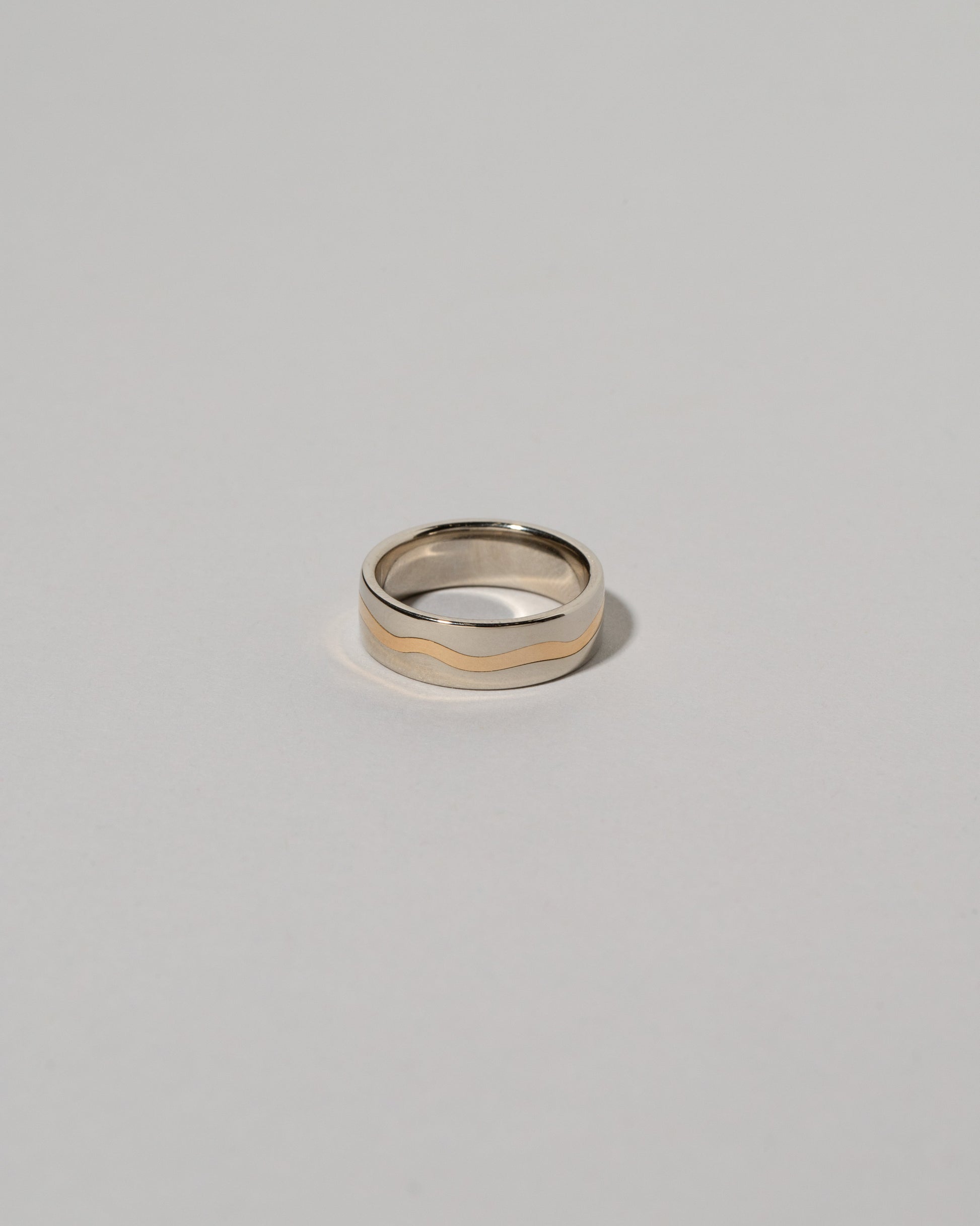 6mm White & Yellow Gold Inlaid Band on light color background.