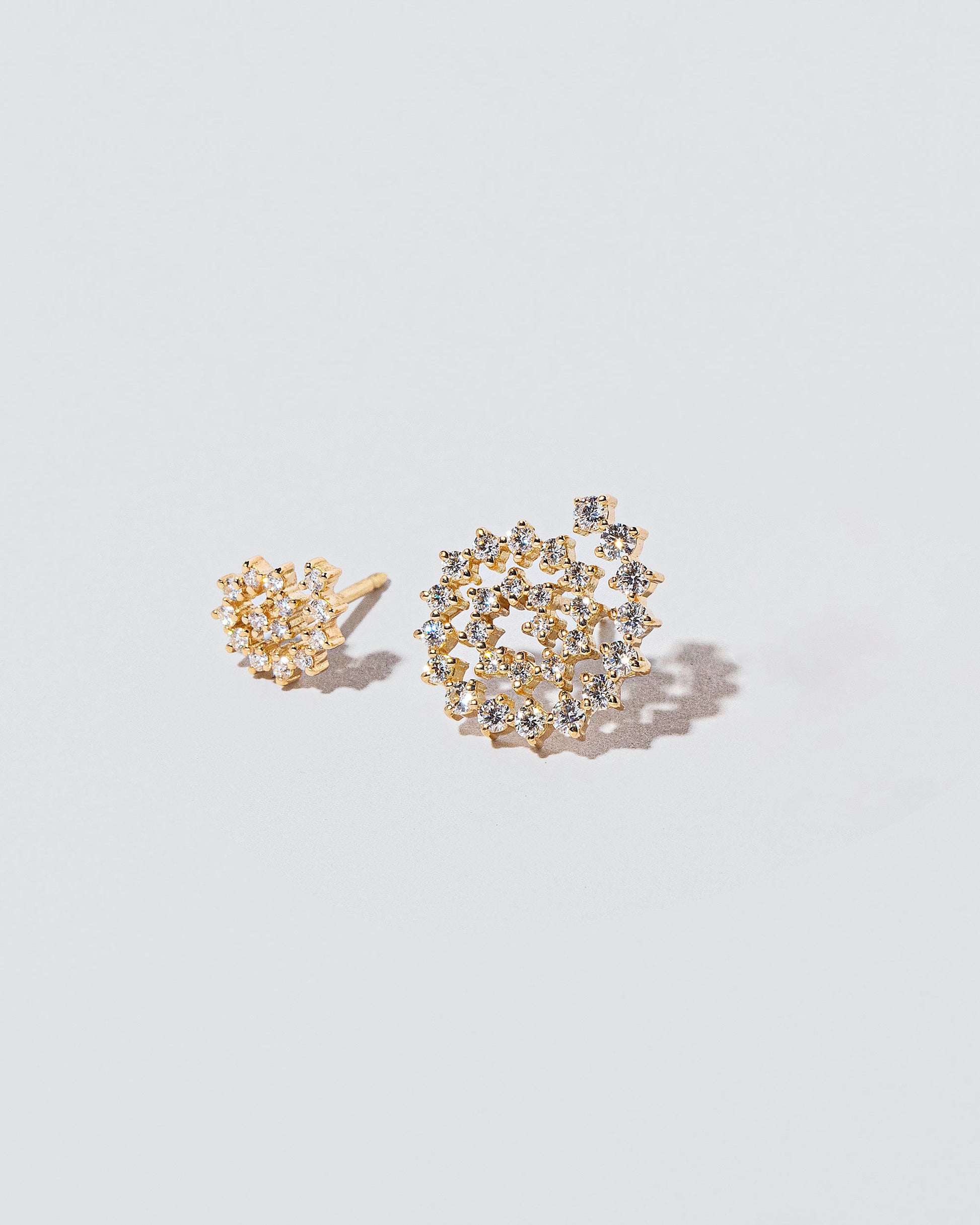 Mini and Full Spiral Earring Single Studs on light colored background.
