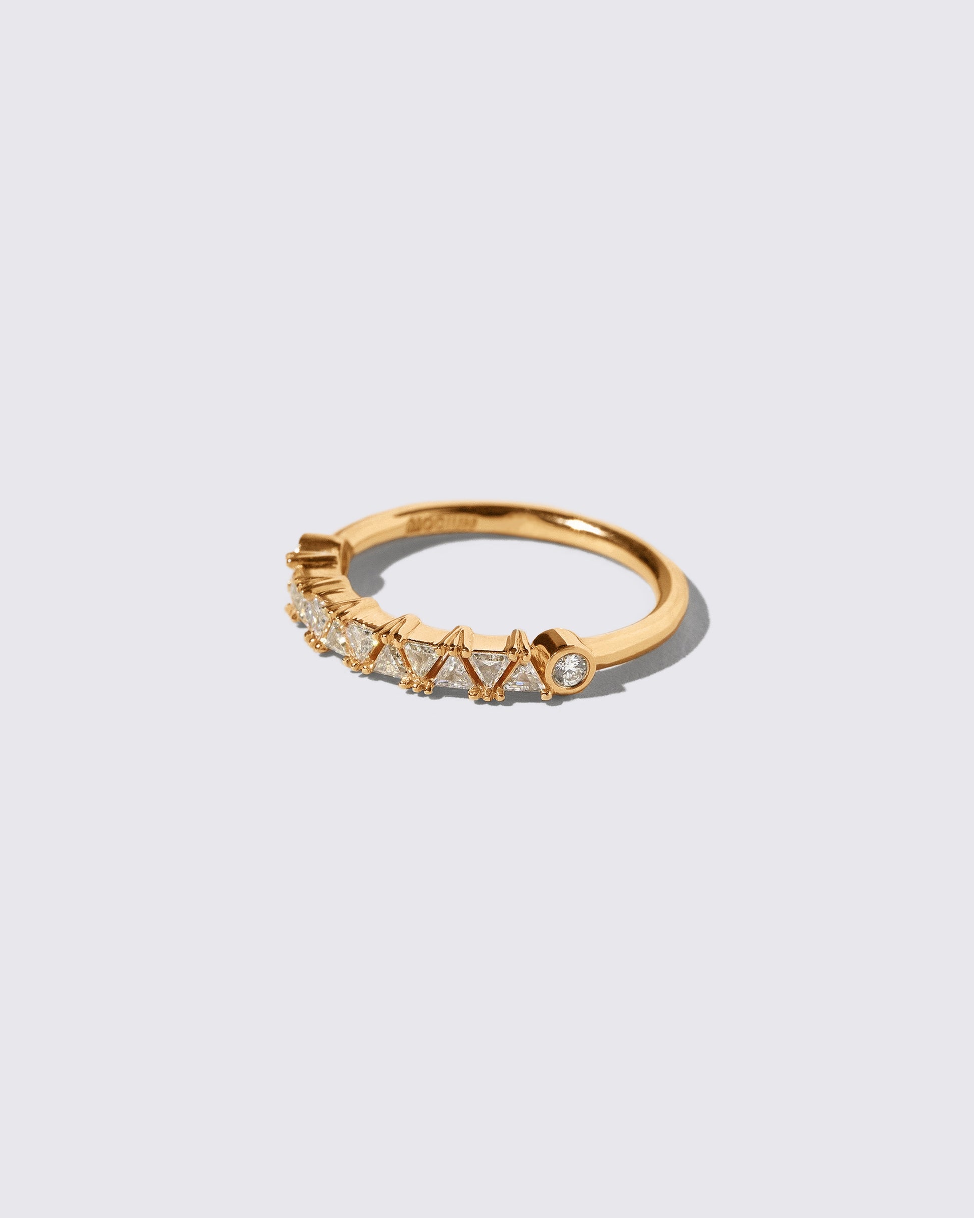 View from the side of the Champagne Diamond Eleven Trillion Ring on light color background.