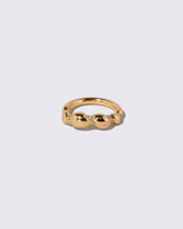 Gold Pavé Bind Band on light color background.