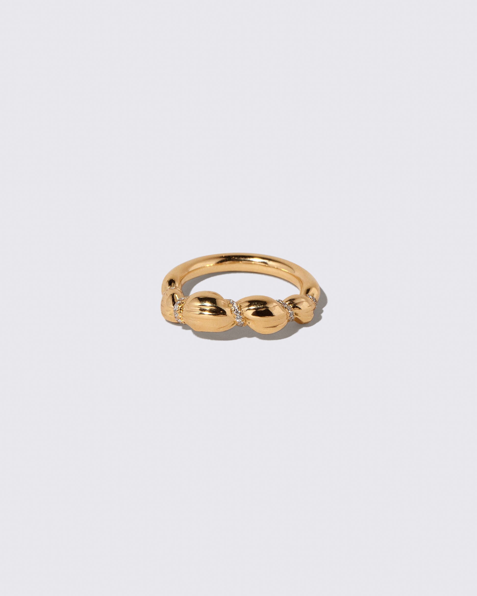 Gold Pavé Bind Band on light color background.