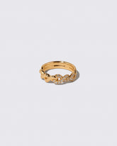 Gold Pavé Twist Band on light color background.