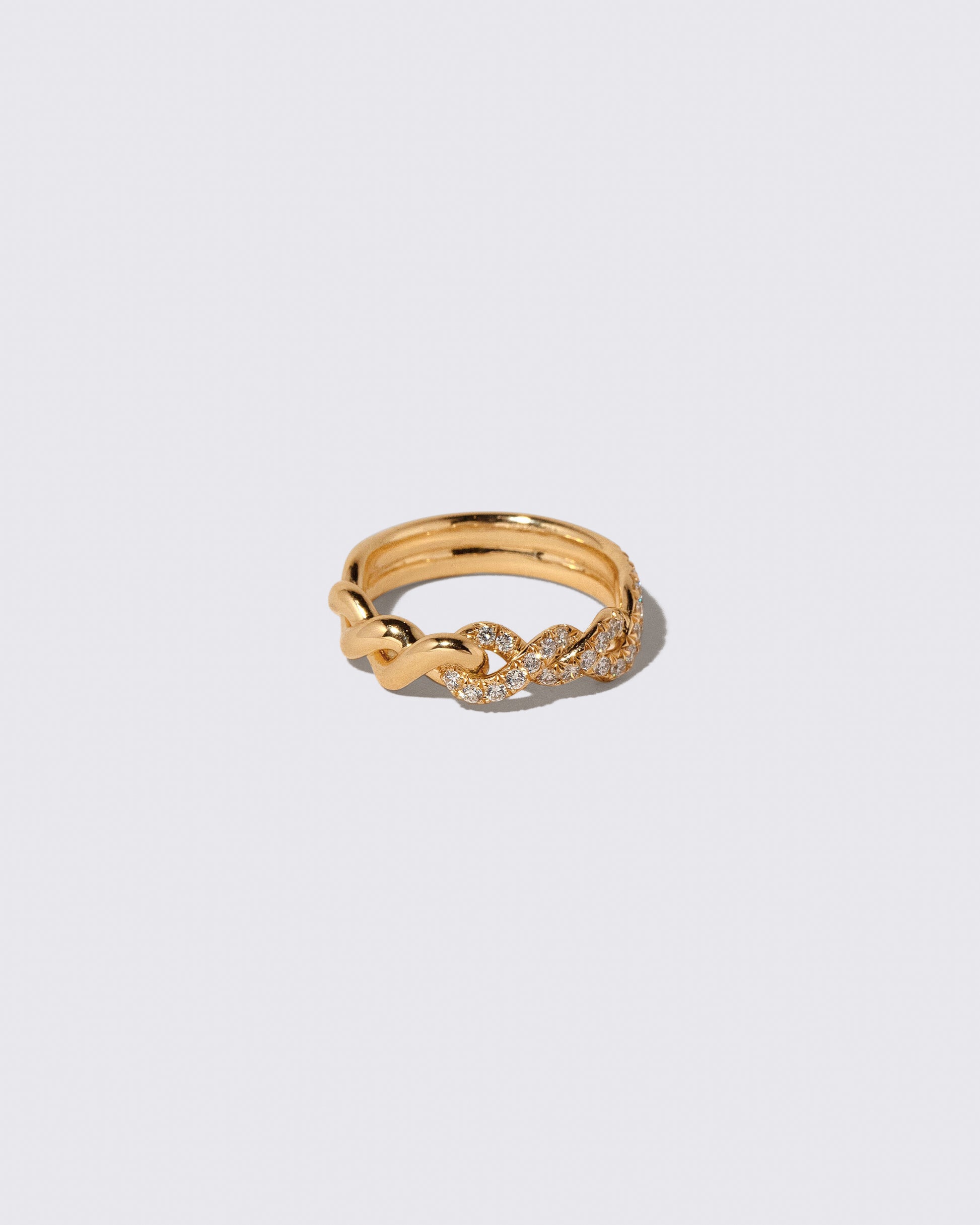 Gold Pavé Twist Band on light color background.