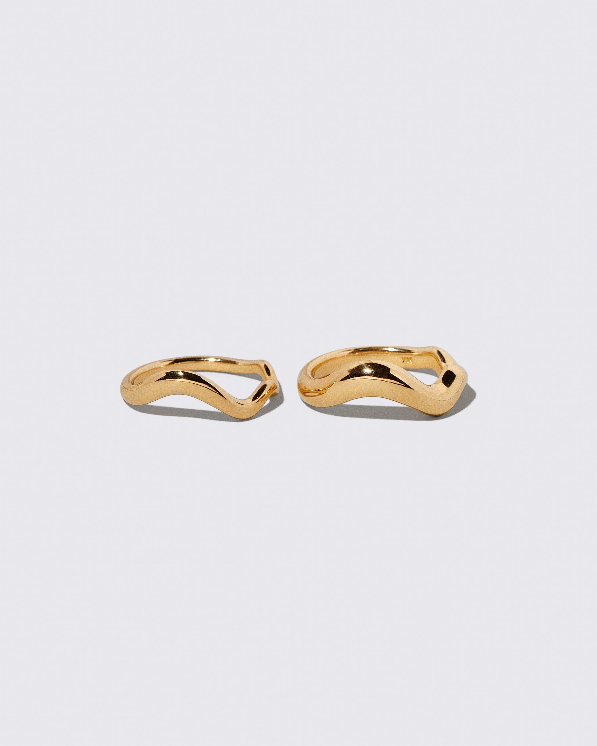 Gold Wide Planate Band and Gold Thin Planate Band on light color background.