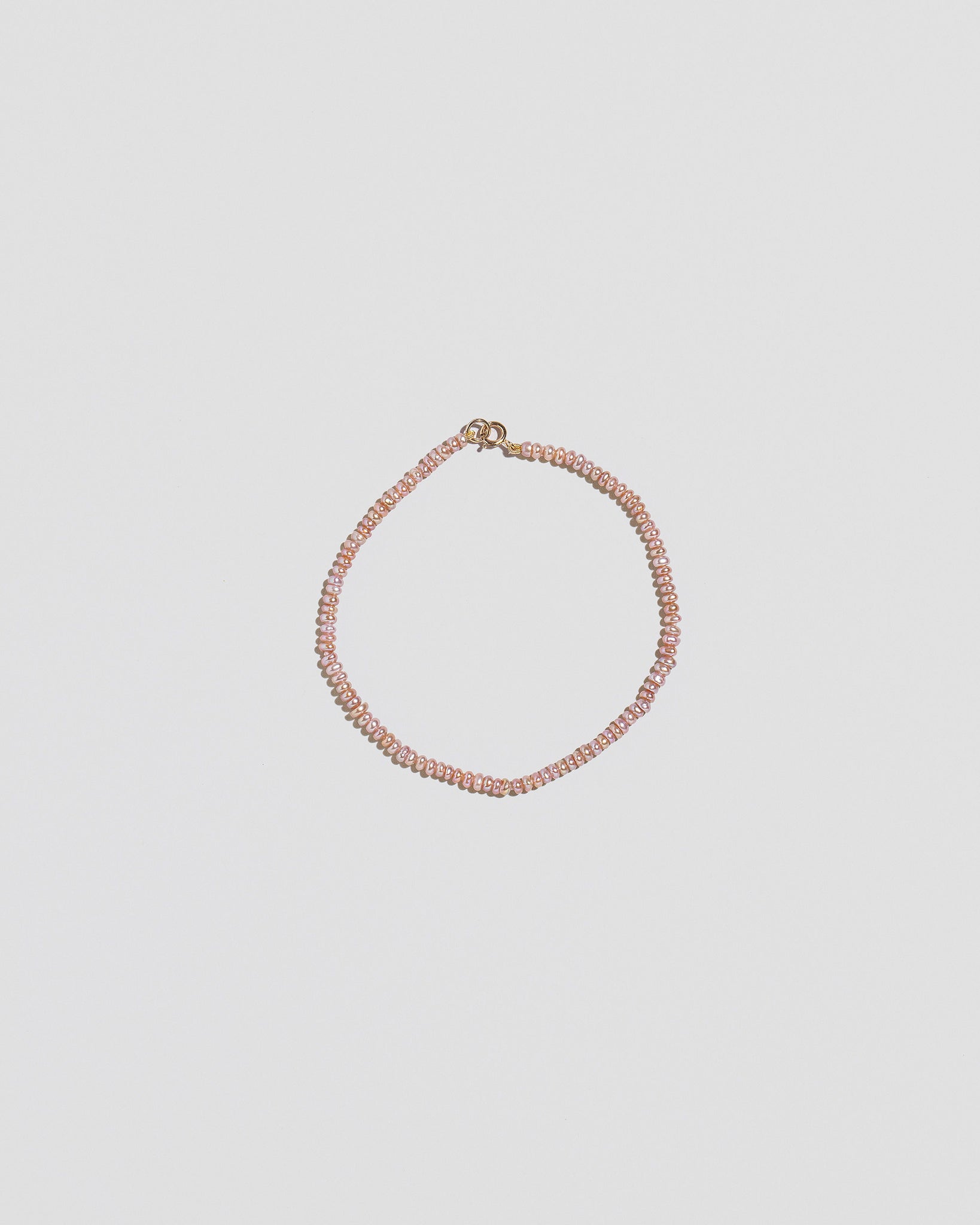 Pink Peony Lavender Seed Pearl Bracelet on light color background.