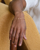 Gold Accumulation Bracelet on male model.