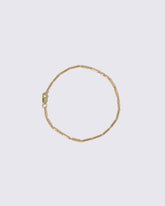Gold Butter Chain Bracelet on light color background.