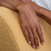 product_details::Hot Dog Chain Bracelet on male model.