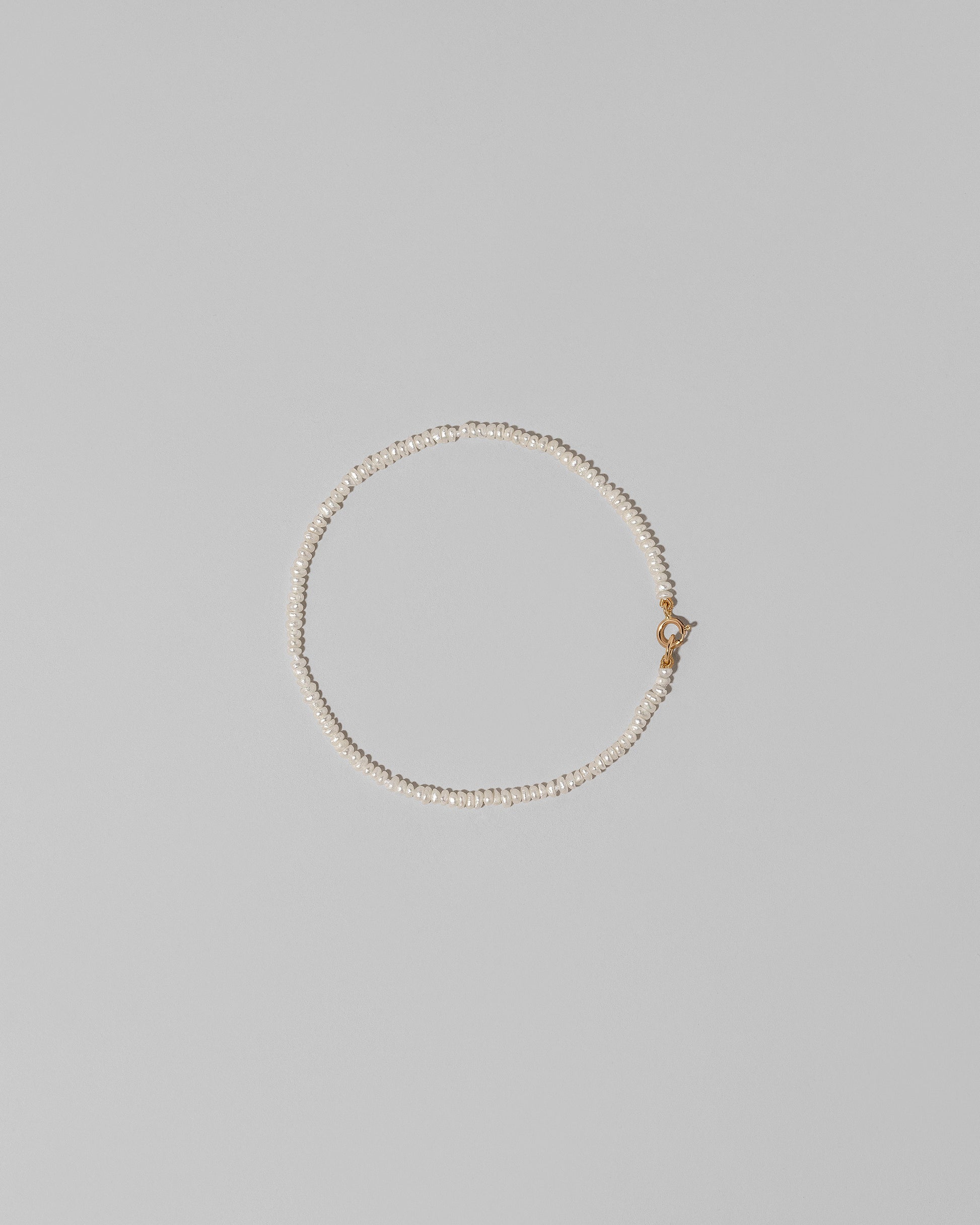 White Seed Pearl Bracelet on light color background.