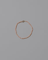 Pink Oval Seed Pearl Bracelet on light color background.