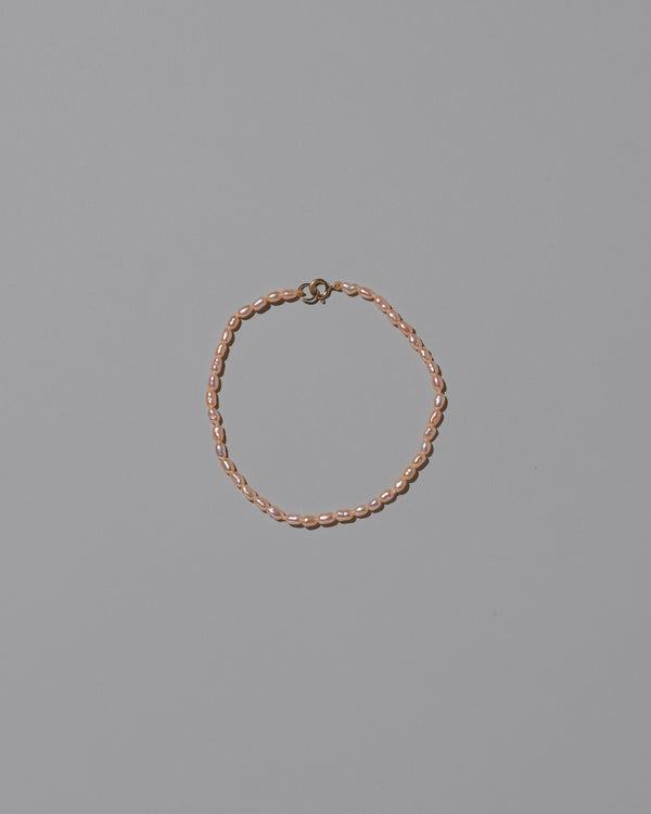 Pink Oval Seed Pearl Bracelet on light color background.