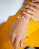 Pink Peony Pebble Seed Pearl Bracelet, Freshwater Pearl Bracelet, Pink Peony Baroque Pearl Bracelet and Pink Oval Seed Pearl Bracelet on model.