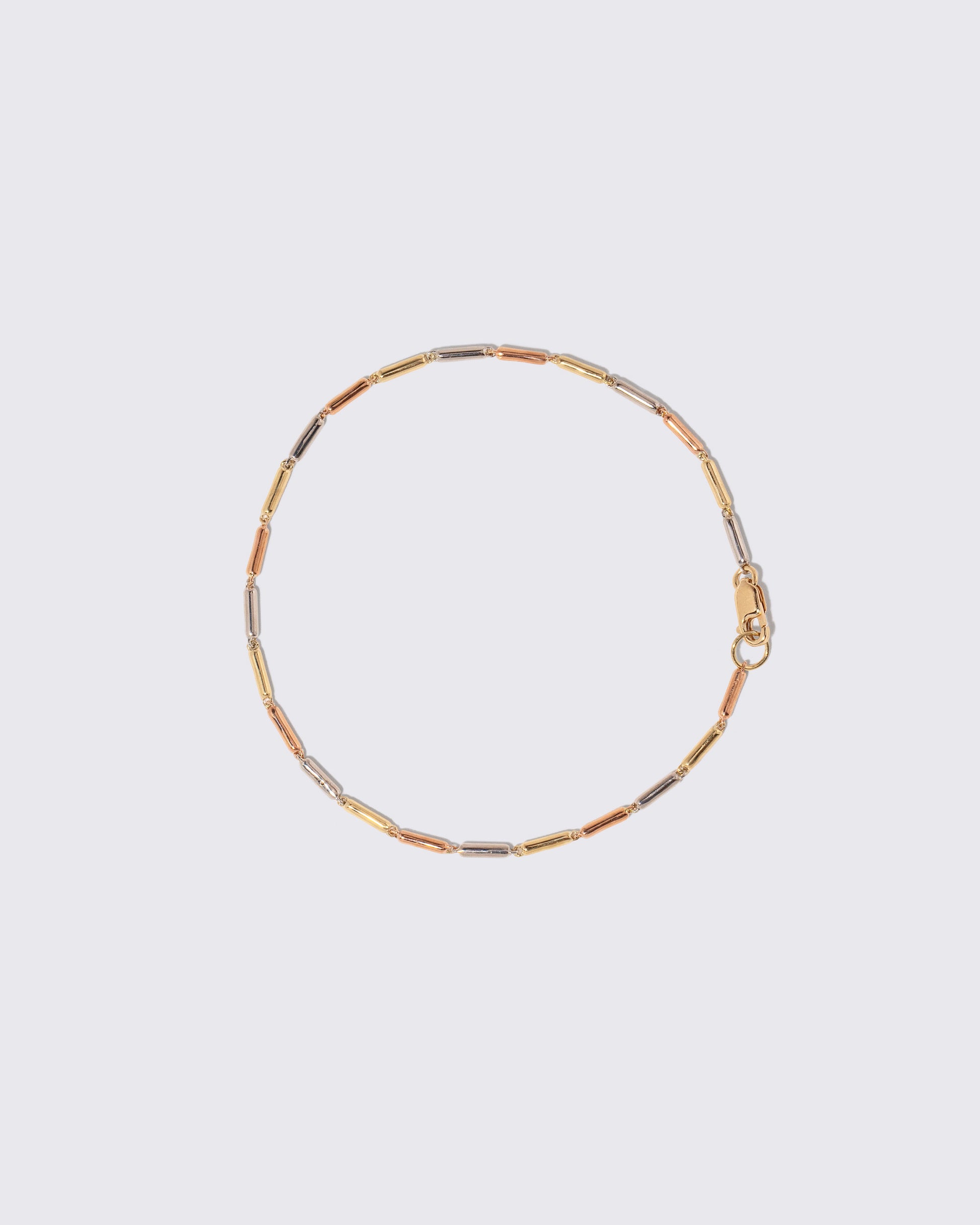 Tricolor Butter Chain Bracelet on light color background.