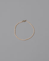 White Oval Seed Pearl Bracelet on light color background.