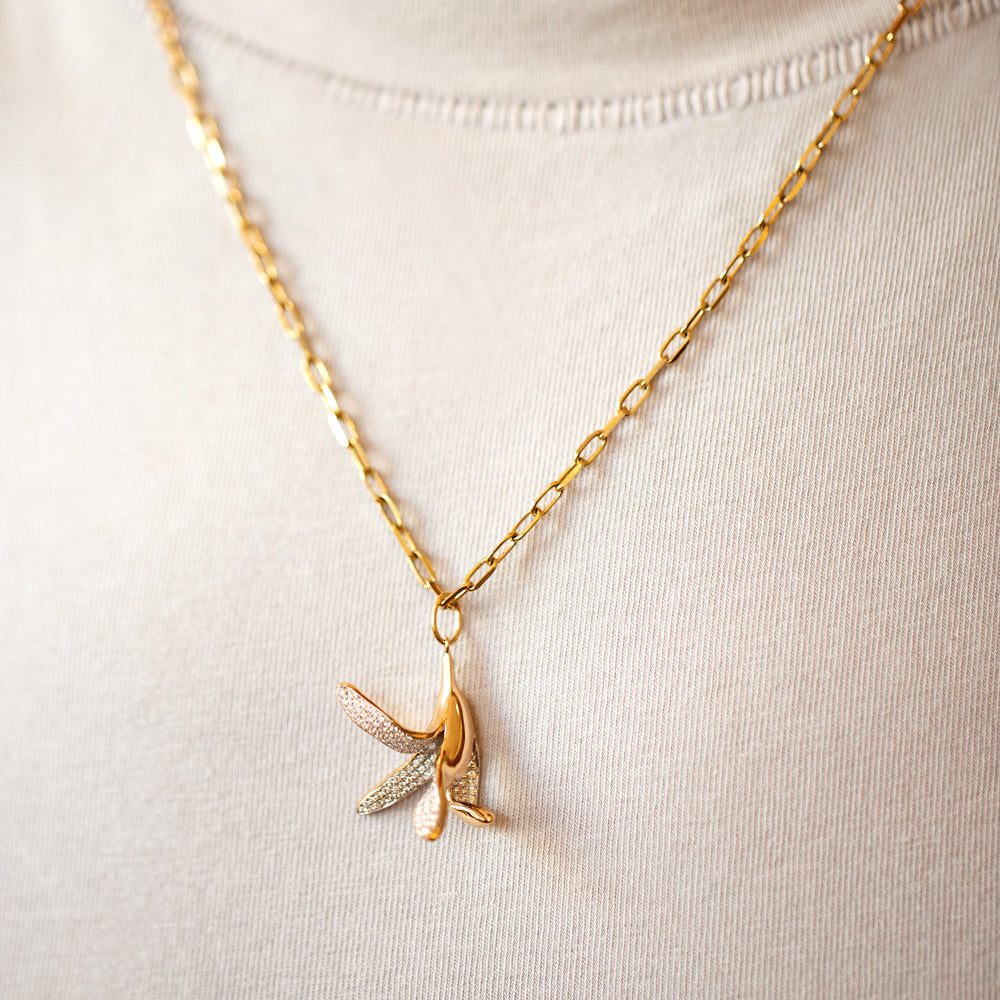 product_details::2.2mm Beveled Oval Chain Necklace and Banana Peel Charm on model.