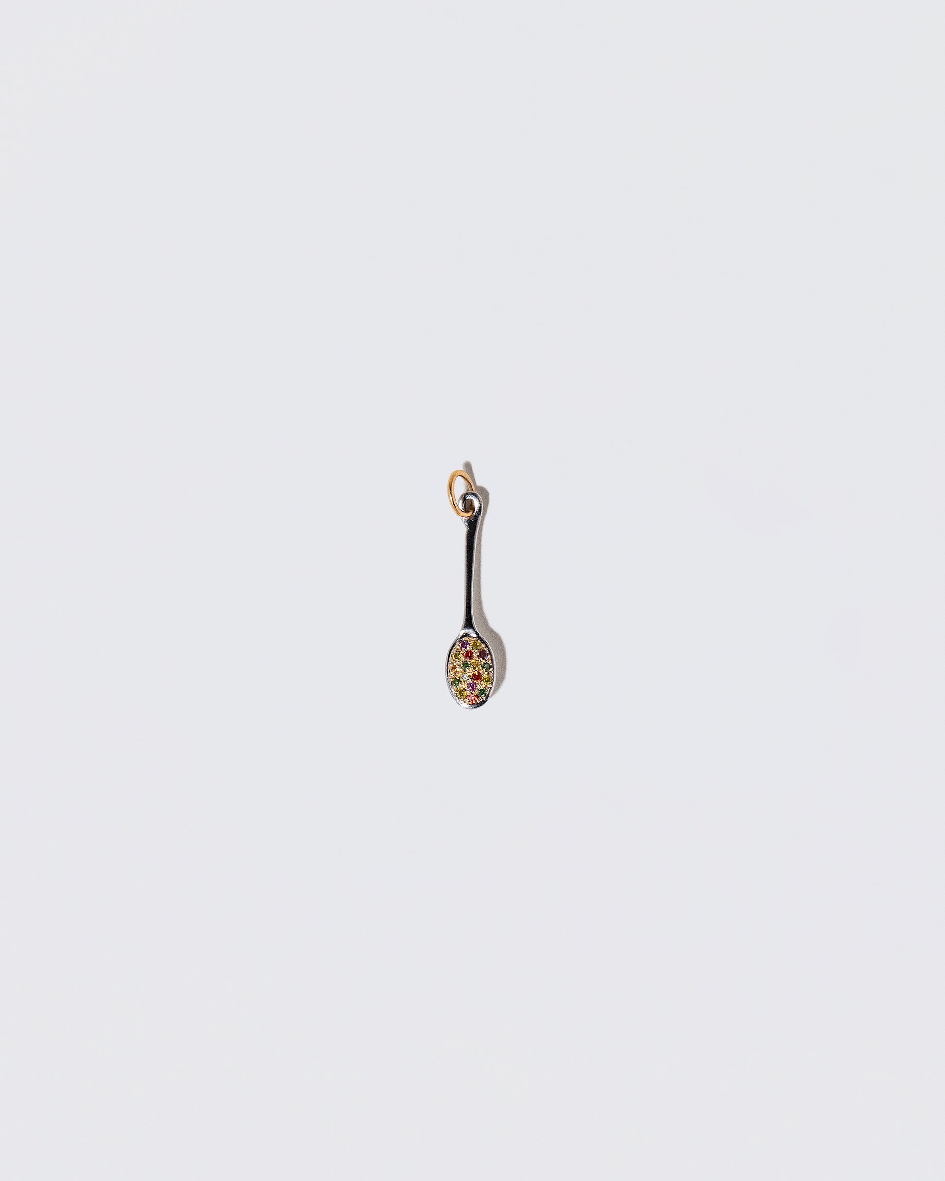 Cereal Spoon Charm on light color background.