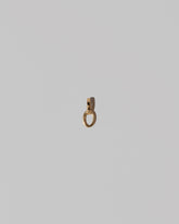 Two Gold Endless Clasp Charms on light color background.