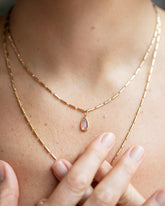 Purple Sapphire Gusher Charm and Gold Butter Chain Necklace on model.