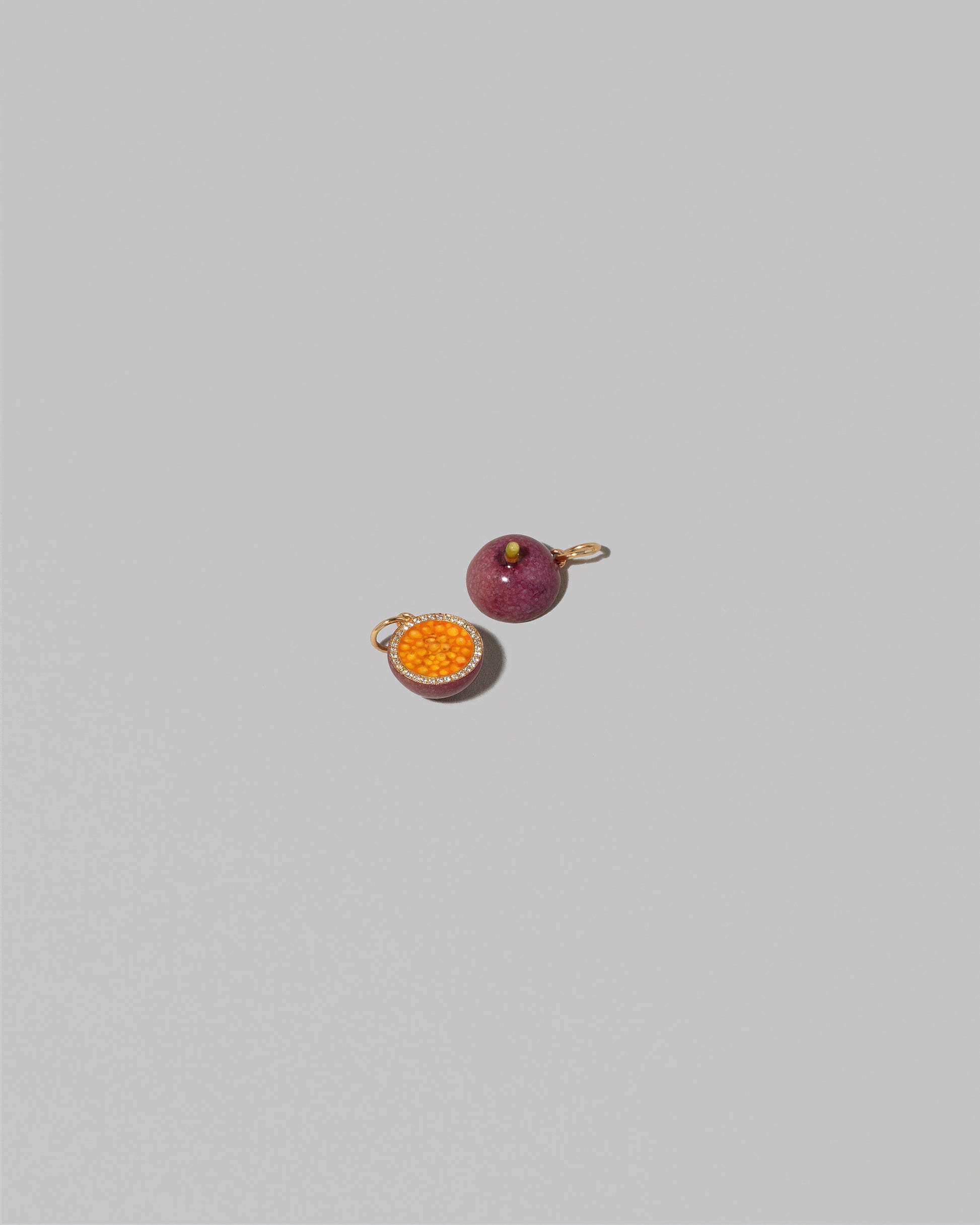 View from the back of the Halved Passion Fruit Charms on light color background.